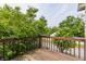 Wooden balcony provides a relaxing outdoor space surrounded by green foliage and tranquil views at 7685 River Rd, Indianapolis, IN 46240
