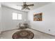Bedroom with ceiling fan, window, carpet, and space for seating and decor, for comfortable living at 7685 River Rd, Indianapolis, IN 46240