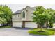 Charming two-story condo featuring attached two car garage and brick accents at 7685 River Rd, Indianapolis, IN 46240