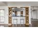 View of kitchen bar featuring wooden cabinets, wine rack and two gray chairs at 7685 River Rd, Indianapolis, IN 46240