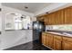 Charming kitchen featuring breakfast bar, black appliances and hardwood floors at 7685 River Rd, Indianapolis, IN 46240