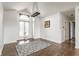 Bright living room featuring large window, modern chandelier and hardwood floors at 7685 River Rd, Indianapolis, IN 46240