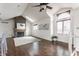 Open-concept living room with a stone fireplace, hardwood floors, and natural light at 7685 River Rd, Indianapolis, IN 46240