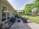Backyard patio with outdoor seating, views of a playset, and a well-manicured lawn at 774 Courtney Cir, Danville, IN 46122