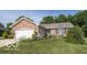Charming single-story home with brick accents, a manicured lawn, and an attached two-car garage at 774 Courtney Cir, Danville, IN 46122