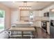 Bright eat-in kitchen boasts white cabinetry, butcher block countertops, and a stylish marble island at 774 Courtney Cir, Danville, IN 46122