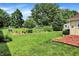 Charming backyard with a garden area and manicured lawn, ideal for relaxation and outdoor enjoyment at 8019 E Hanna Ave, Indianapolis, IN 46239