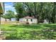 Spacious backyard featuring a detached garage, new wooden fence, and plenty of grassy area at 8019 E Hanna Ave, Indianapolis, IN 46239