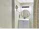 Bathroom featuring a gray vanity with a round mirror, modern lighting, and patterned shower curtain at 8019 E Hanna Ave, Indianapolis, IN 46239