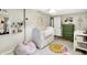 Adorable Bedroom with crib, changing table, plush seating, and ample natural light at 8019 E Hanna Ave, Indianapolis, IN 46239