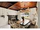 The dining room features a fireplace, modern light fixture, and large window with a backyard view at 8019 E Hanna Ave, Indianapolis, IN 46239