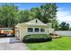 Charming home featuring professional landscaping, mature trees, and a covered patio at 8019 E Hanna Ave, Indianapolis, IN 46239
