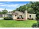 Charming home featuring professional landscaping, mature trees, and a well-maintained lawn at 8019 E Hanna Ave, Indianapolis, IN 46239