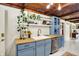 Charming kitchen with blue cabinets, butcher block counters, stainless steel appliances, and tile backsplash at 8019 E Hanna Ave, Indianapolis, IN 46239