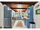 Charming kitchen with blue cabinets, butcher block counters, stainless steel appliances, and a view of the backyard at 8019 E Hanna Ave, Indianapolis, IN 46239