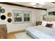 Bedroom with wood flooring, neutral walls, and two large windows providing a view to the outdoors at 8019 E Hanna Ave, Indianapolis, IN 46239