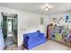 A cute, colorful playroom includes a blue sofa and play kitchen at 8019 E Hanna Ave, Indianapolis, IN 46239