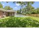 Private backyard with a covered pool, screened porch, and a secure wooden fence at 8246 Windcombe Blvd, Indianapolis, IN 46240