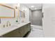 Modern bathroom with double sinks, sleek gray tiling, and a frameless glass shower at 8246 Windcombe Blvd, Indianapolis, IN 46240