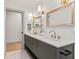 Elegant bathroom featuring a double vanity, stylish mirrors, and modern fixtures at 8246 Windcombe Blvd, Indianapolis, IN 46240