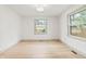 Bright bedroom featuring hardwood floors, natural light from a window, and neutral paint colors at 8246 Windcombe Blvd, Indianapolis, IN 46240