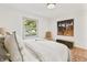 Bright bedroom with light walls, modern art, and large window with lush outdoor views at 8246 Windcombe Blvd, Indianapolis, IN 46240