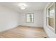 Empty bedroom with hardwood floors and windows providing natural light and outdoor views at 8246 Windcombe Blvd, Indianapolis, IN 46240