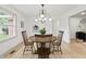 Bright dining area featuring a round wooden table, comfortable chairs, and modern artwork at 8246 Windcombe Blvd, Indianapolis, IN 46240