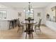 Charming dining room featuring a round wooden table, stylish chandelier, and bright natural light at 8246 Windcombe Blvd, Indianapolis, IN 46240
