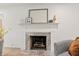 Elegant fireplace with marble surround, framed by a classic white mantel and decorative items at 8246 Windcombe Blvd, Indianapolis, IN 46240