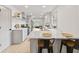 Contemporary kitchen featuring a breakfast bar with seating, stainless steel appliances, and bright natural light at 8246 Windcombe Blvd, Indianapolis, IN 46240