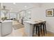 Modern kitchen with a breakfast bar, stainless steel appliances, and an open layout to the living area at 8246 Windcombe Blvd, Indianapolis, IN 46240