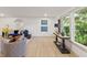 Bright and stylish living room featuring large windows, hardwood floors and comfortable seating at 8246 Windcombe Blvd, Indianapolis, IN 46240