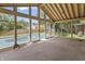 Bright screened-in porch featuring a high ceiling and views of the backyard pool area at 8246 Windcombe Blvd, Indianapolis, IN 46240