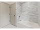 Bathroom shower featuring tiled surround and modern fixtures at 8246 Windcombe Blvd, Indianapolis, IN 46240