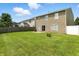 A large backyard with a wood fence, a well-maintained lawn, and a patio at 8301 Wheatfield Dr, Camby, IN 46113