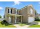 This angle showcases the home's architecture and curb appeal on a sunny day at 8301 Wheatfield Dr, Camby, IN 46113