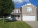 Charming two-story home with a two car garage, a well kept yard, and a covered entryway at 8301 Wheatfield Dr, Camby, IN 46113