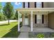 A close up of the front porch showing the brick facade and covered entryway at 8301 Wheatfield Dr, Camby, IN 46113