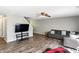 Comfortable living room with ceiling fan, gray walls and hard surface floors at 8301 Wheatfield Dr, Camby, IN 46113