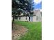 Spacious backyard features a well-manicured lawn and mature trees, providing ample space at 8326 Alcona Dr, Indianapolis, IN 46237
