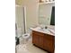 Bathroom with double vanity, toilet, and glass-enclosed shower at 8326 Alcona Dr, Indianapolis, IN 46237