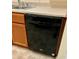 Close-up of the kitchen featuring a black dishwasher with light wood cabinets at 8326 Alcona Dr, Indianapolis, IN 46237