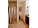 Cozy bathroom features tiled floors, a shower with shower curtain, and a wood vanity at 8333 Pine Branch Ln, Indianapolis, IN 46234