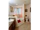 Bright bathroom showcasing an undermount sink, soaking tub, and ceramic tile floors at 8333 Pine Branch Ln, Indianapolis, IN 46234