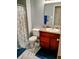 Cozy bathroom featuring a single sink vanity, toilet, and a shower with a patterned curtain, offering essential amenities at 8333 Pine Branch Ln, Indianapolis, IN 46234