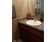 A bathroom sink featuring a dark wood cabinet, countertop, mirror and towels at 8333 Pine Branch Ln, Indianapolis, IN 46234