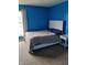 Bright blue bedroom with a comfortable bed and ample natural light, creating a peaceful and inviting atmosphere at 8333 Pine Branch Ln, Indianapolis, IN 46234