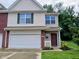 Two story home featuring vinyl siding, attached two-car garage and landscaped front yard at 8333 Pine Branch Ln, Indianapolis, IN 46234