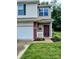 Close up of a front exterior featuring vinyl siding, attached two-car garage and landscaped front yard at 8333 Pine Branch Ln, Indianapolis, IN 46234
